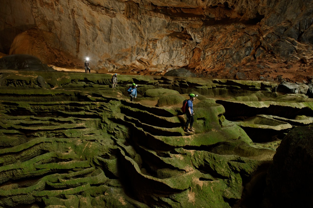 VIETNAM - MAY 02:  Hang Son Doong explorers navigate an algae-covered cavescape.  (Photo by Carsten Peter/National Geographic/Getty Images)